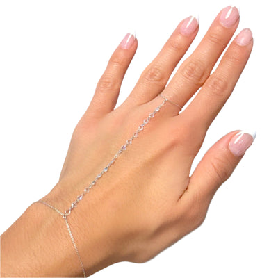 Hand wearing a delicate silver bracelet on a white background
