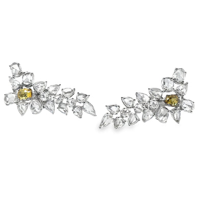 Pair of diamond earrings with yellow gemstones on a white background