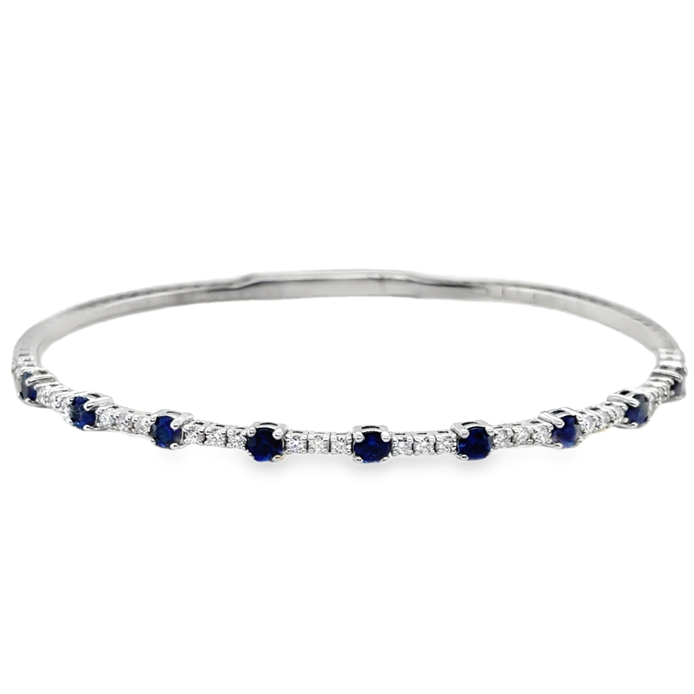 Silver bracelet with blue and clear stones on a white background